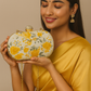 Gold yellow oval shape floral print hand clutch with sling